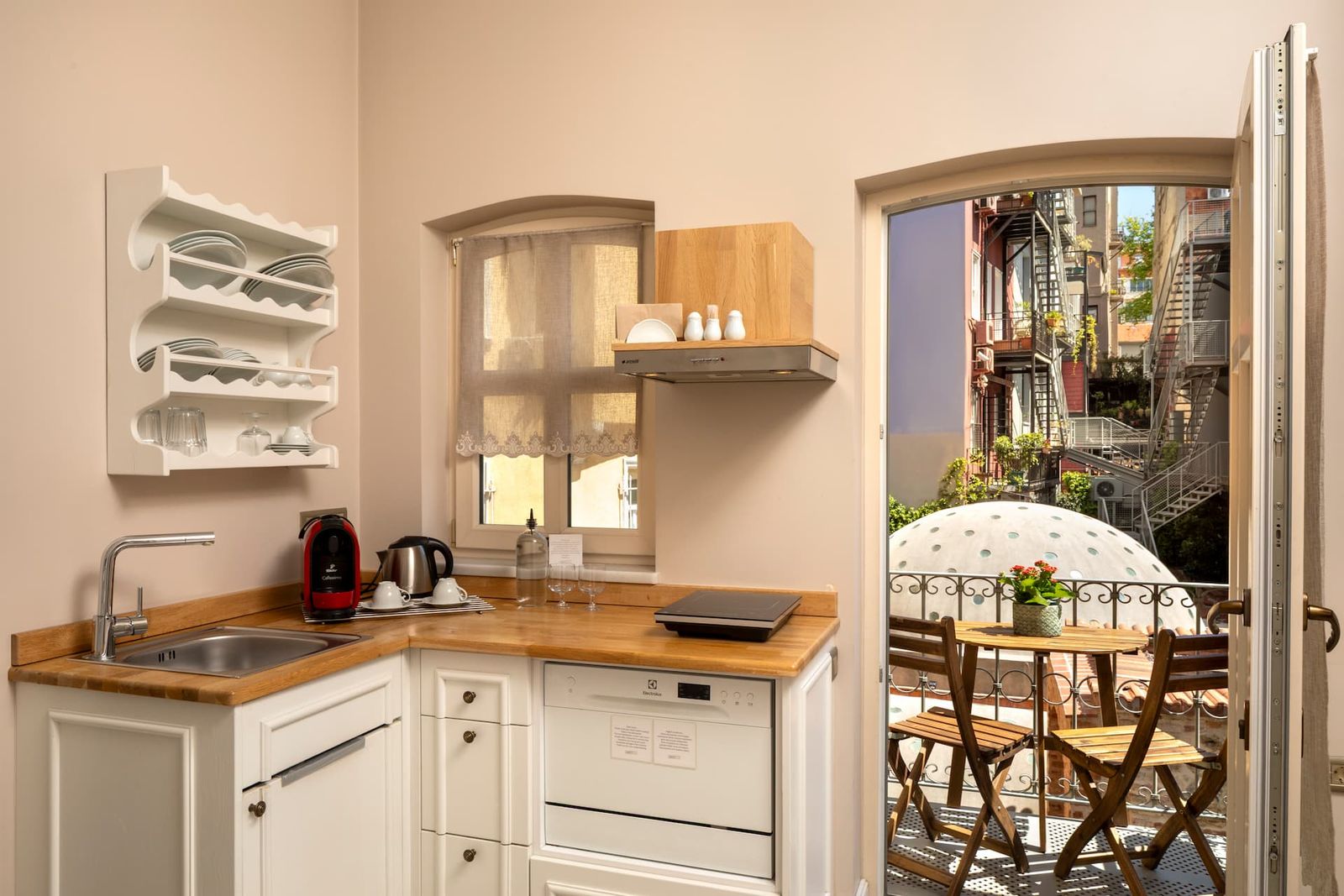 A second view of the kitchen and dining corner of the One-Bedroom, with the small espresso station on the counter.