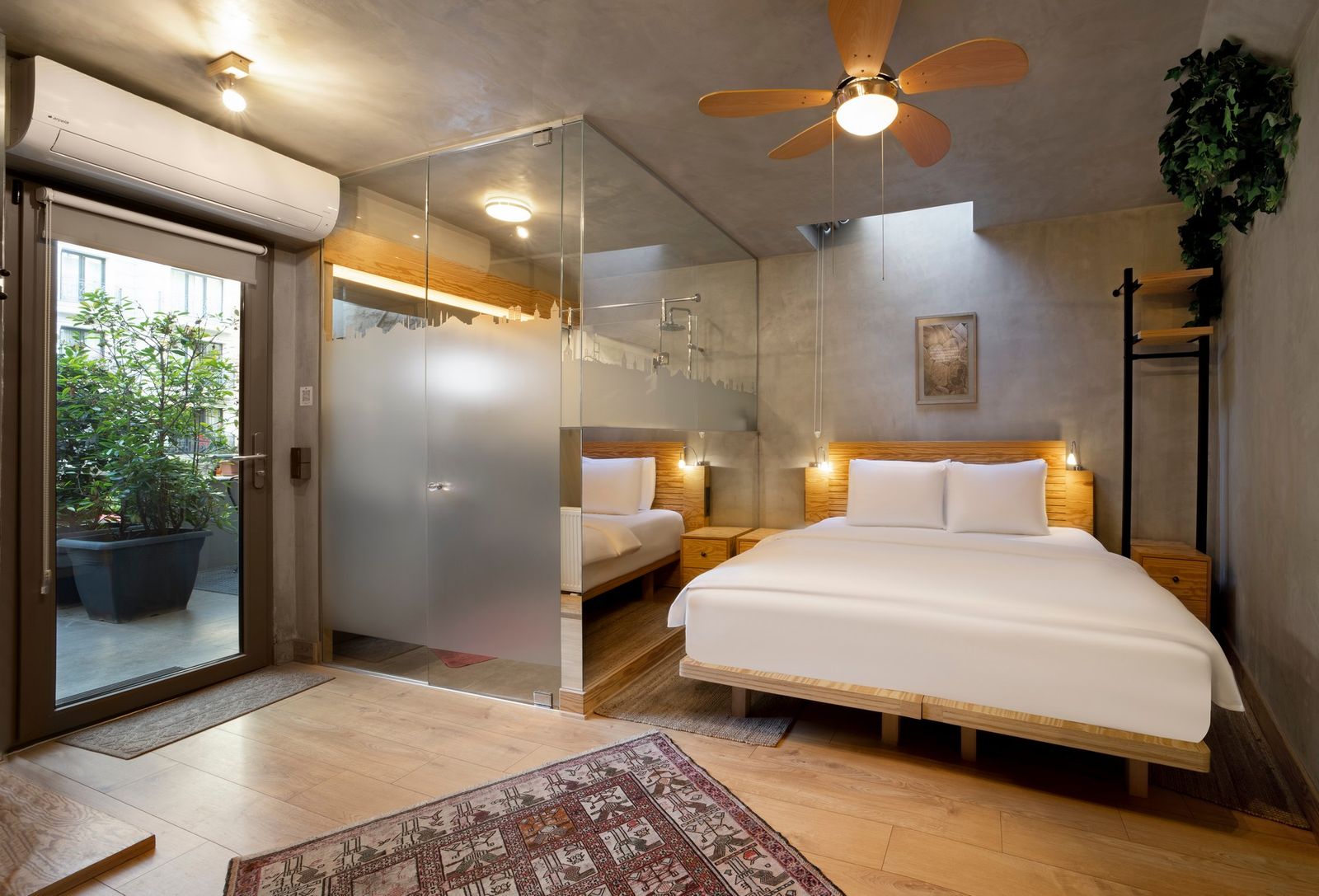 The interior of the Patio Room — bed against the side wall, the small writing desk by the window, frosted glass to the bathroom at the rear.