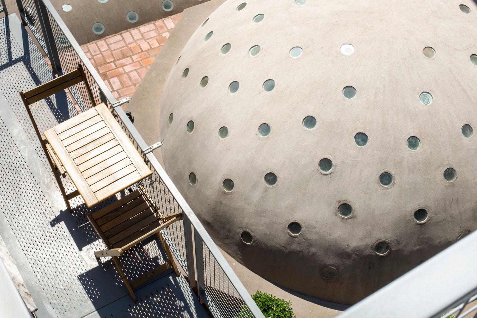 A wider view from the balcony down the length of Çukurcuma Street, the hamam dome anchoring the end of the lane.