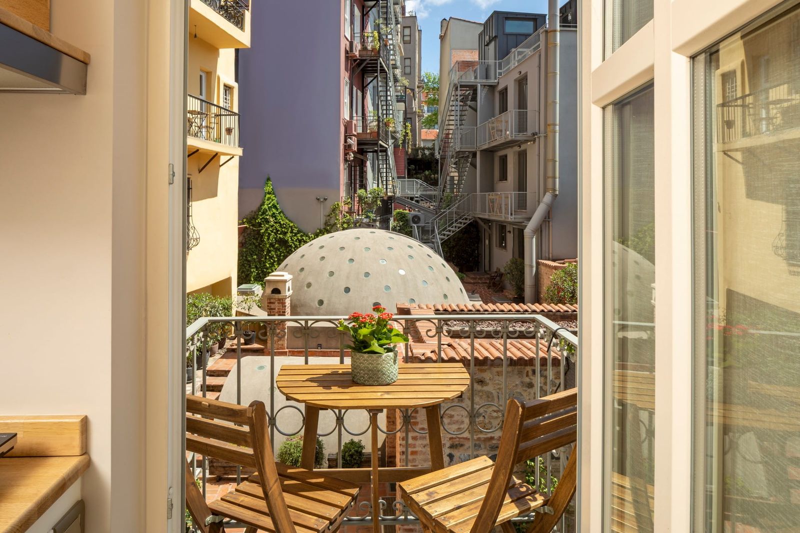 The view from the Balcony Apartment's Juliet balcony — Çukurcuma Street below, antique dealers, the curve of the lane.