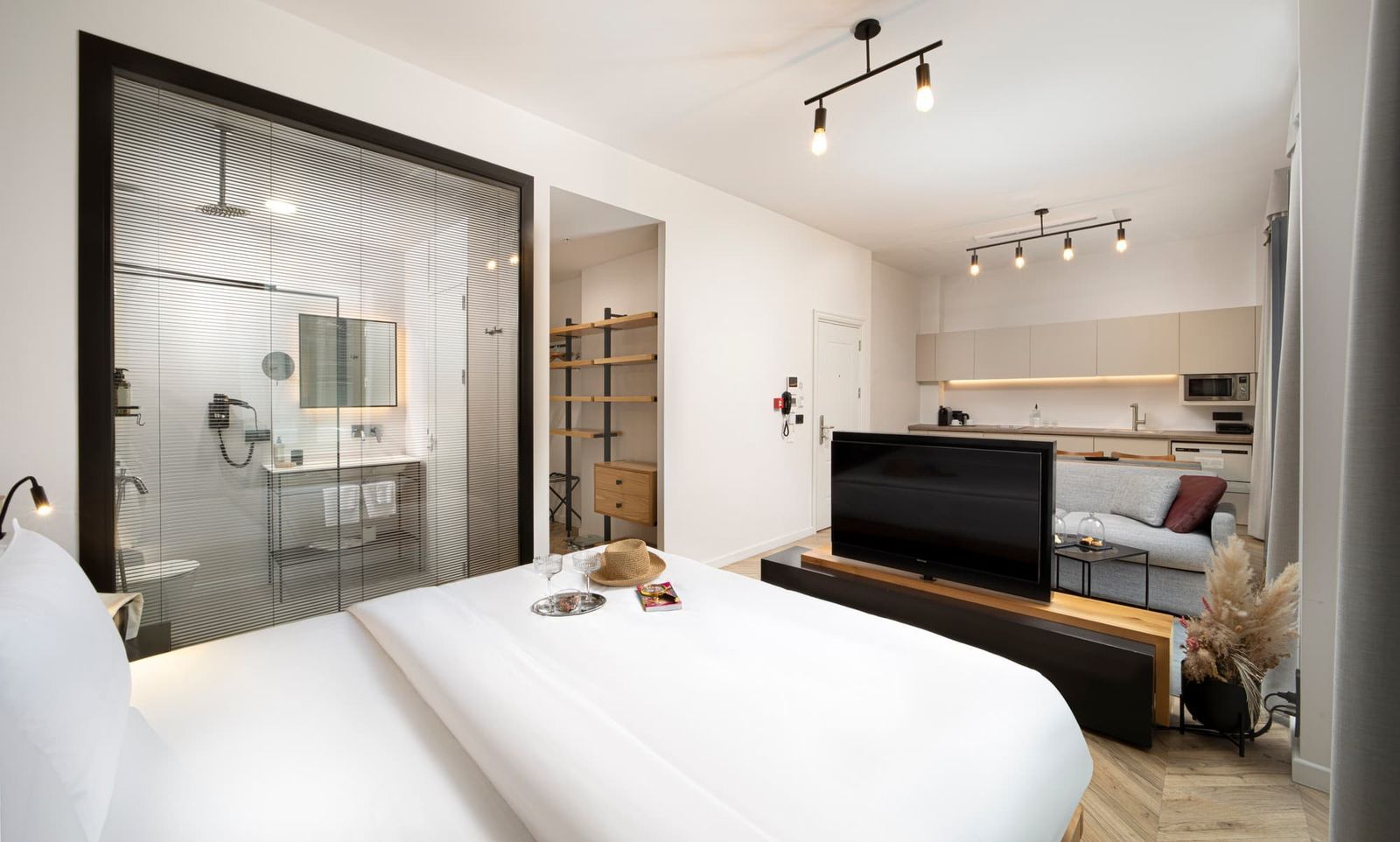 The upper bedroom of the Duplex — bed under the eaves, a small writing desk against the dormer window.